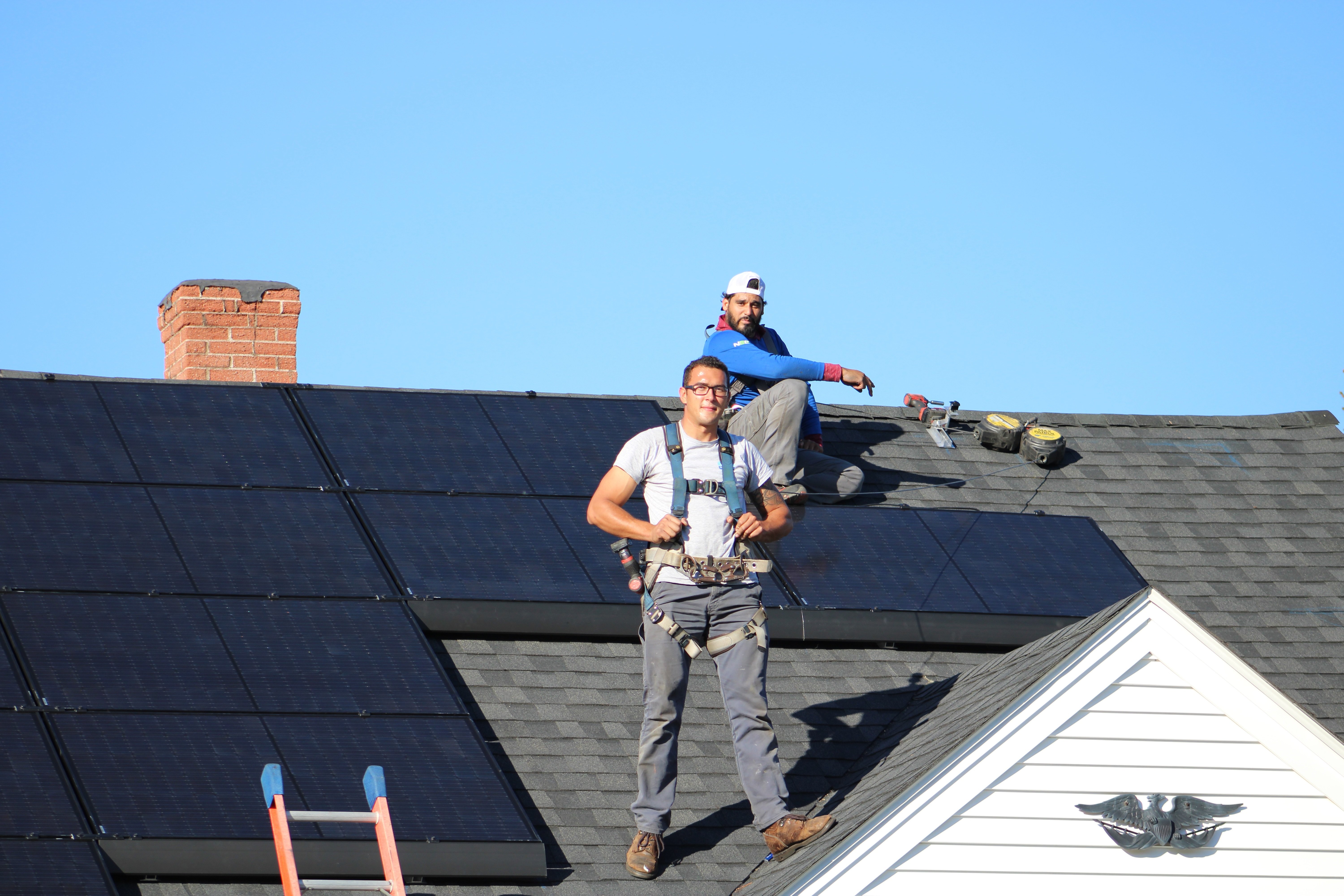 Workers installing solar on a roof